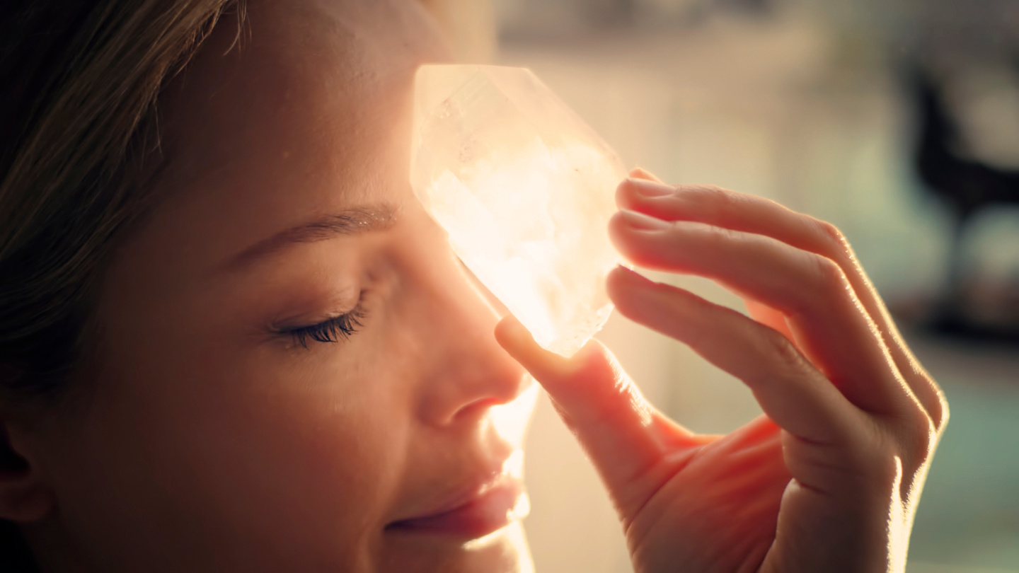 Woman's head with a healing crystal.