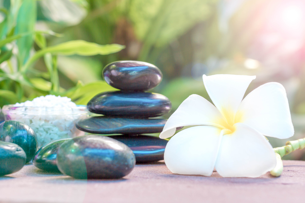 Spa treatment with Frangipani and black stones.