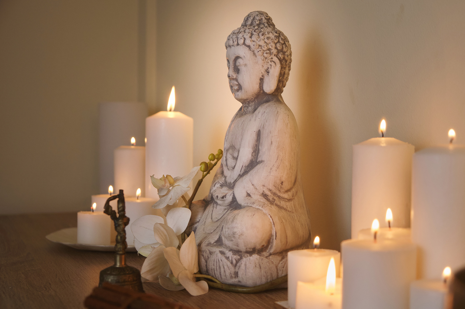 Buddha figure among candles. wellness spa concept